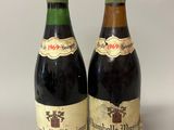 two bottles of wine sitting next to each other on a table