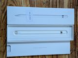 an apple pencil in a white box on a wooden surface