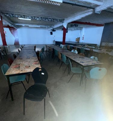 many tables and chairs in a room that is empty