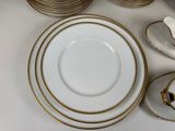 many plates and cups and saucers on the table