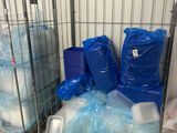 two metal cages filled with plastic bottles and containers on top of a wooden pallet