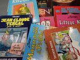 many children ' s books that are on the table