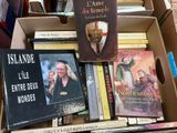 books in a cardboard box are stacked on top of each other