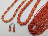 an orange beaded necklace and earring set with matching earrings