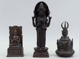 three bronze figurines of hindu deities on a white background