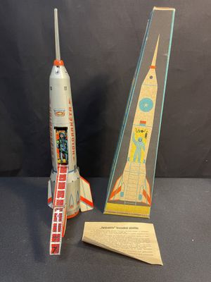 two toy rockets sit next to each other on a table