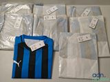 a group of blue and black soccer shirts sitting on top of a table