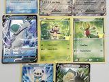 several pokemon cards sitting on top of each other on a table