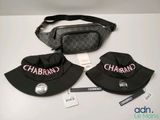 two hats and a fanny bag are sitting on a table