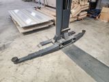 a fork lift in the middle of a warehouse floor