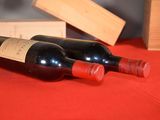 two bottles of wine sitting next to each other on a table
