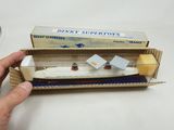 a person holding a box with a model of a boat in it