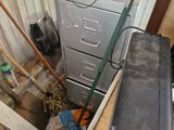 a metal filing cabinet in the corner of a room