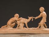 statue of a boy and a boy with a goat in a field