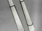 pair of white marble candles with black wire wrapped around them
