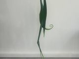 a sculpture of a bird holding a flower in it ' s beak