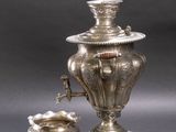 a silver plate with a silver vase and a bowl on top of it