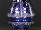 an image of a blue glass egg on a stand