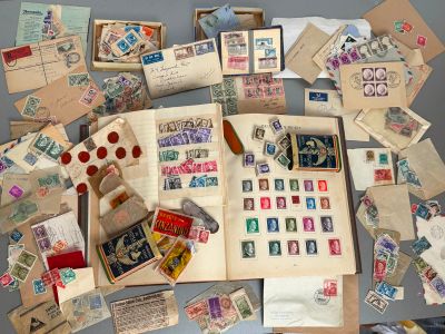 a lot of stamps on the table with a teddy bear