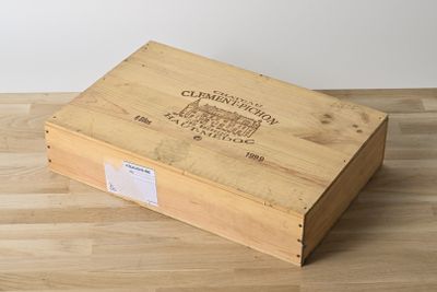 a wooden box with a label on it sitting on a wooden floor