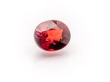 a red garnet stone on a white background