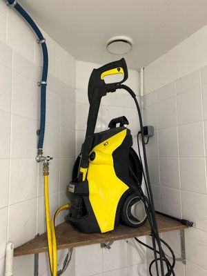 a yellow and black pressurer sitting on a shelf in a bathroom