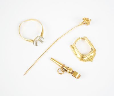 an assortment of gold and diamond jewelry including a ring, a stick, and a pin