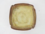 an image of a brown and white plate on a white surface