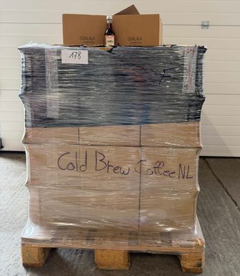 boxes of cold brew sit on pallets in a warehouse