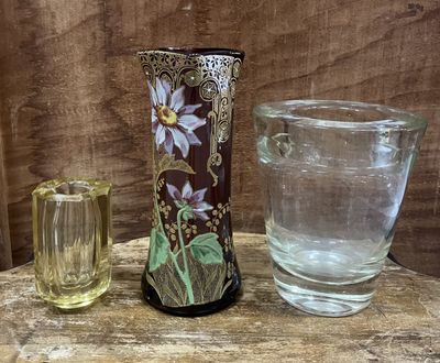a vase and a glass sitting on a table