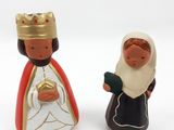 two figurines of a man and a woman dressed in traditional clothes