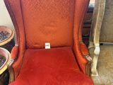 an image of a red chair sitting in a room next to a table