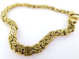a close up of a gold chain bracelet on a white background