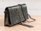 a close up of a black purse on a wooden table