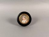 an oval miniature portrait of a woman in a white hat