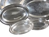 a lot of silver trays sitting on a table