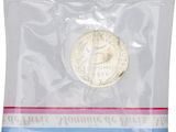 the coin is in a clear plastic bag with a red, white, and blue stripe