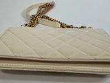 a close up of a white purse on a white table