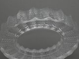 a clear glass bowl with a decorative design on it
