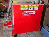 a red machine that is sitting in the dirt