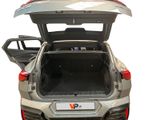 the back of a silver car with its trunk open on a white background