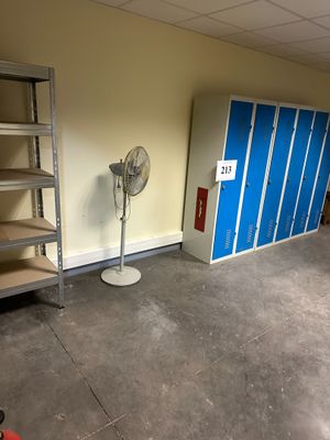 an image of a room with shelves and a fan in it