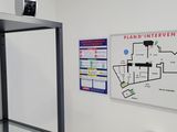 an image of a bathroom with a toilet and a map on the wall