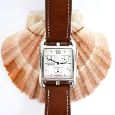 a watch that is sitting on top of a shell