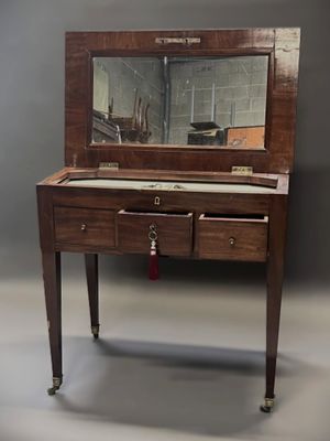 a small desk with a mirror on top of it
