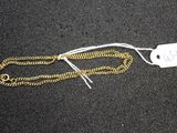 a close up of a gold chain with a price tag on it
