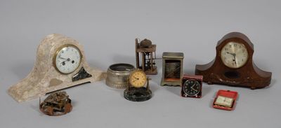 many different types of clocks displayed on a table
