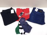four pairs of men ' s jeans are laid out on a white surface