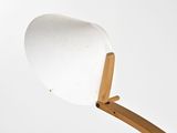 a white lamp that is on top of a wooden stand