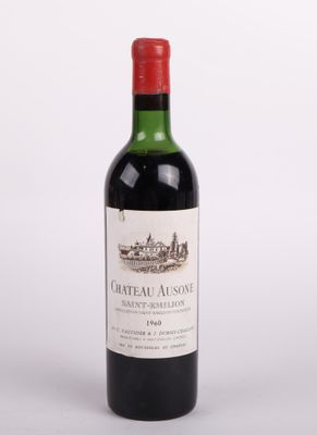 une bouteille de vin rouge posée sur une table blanche